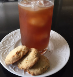 3 shortbread cookies and a glass of iced tea on a white plate