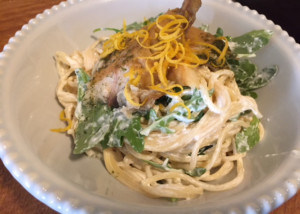 bowl of pasta with mackerel and arugula