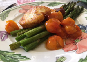 a plate with roasted asparagus, haloumi and cherry tomatoes