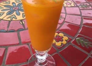 glass of turmeric tonic on a colorful table